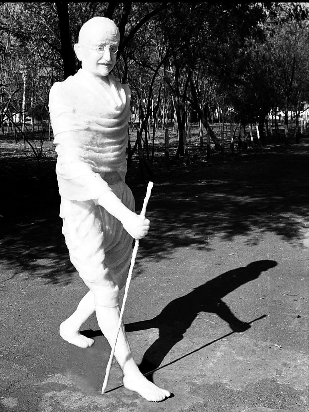 Life-size cotton sculpture of Mahatma Gandhi, walking with a staff